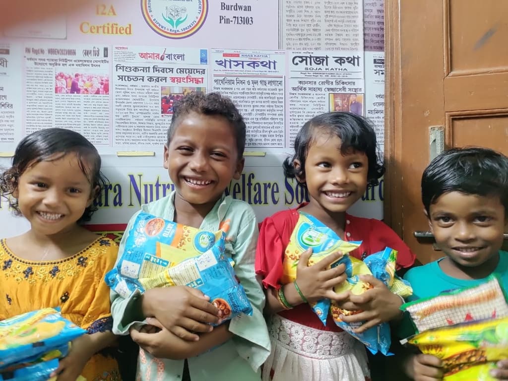 Smiling Children holding Nutritious Food